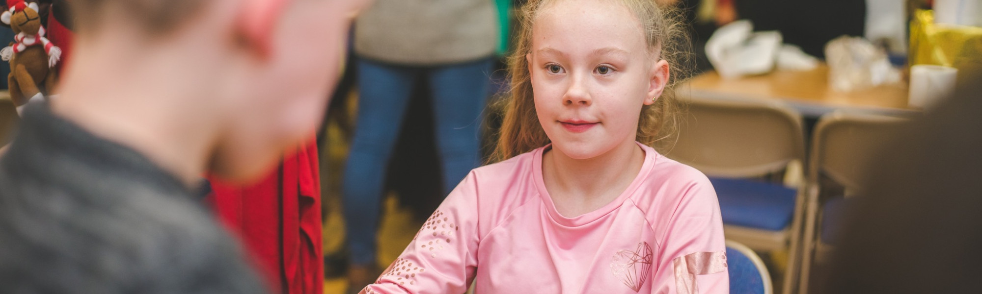 Young girl talking to another child