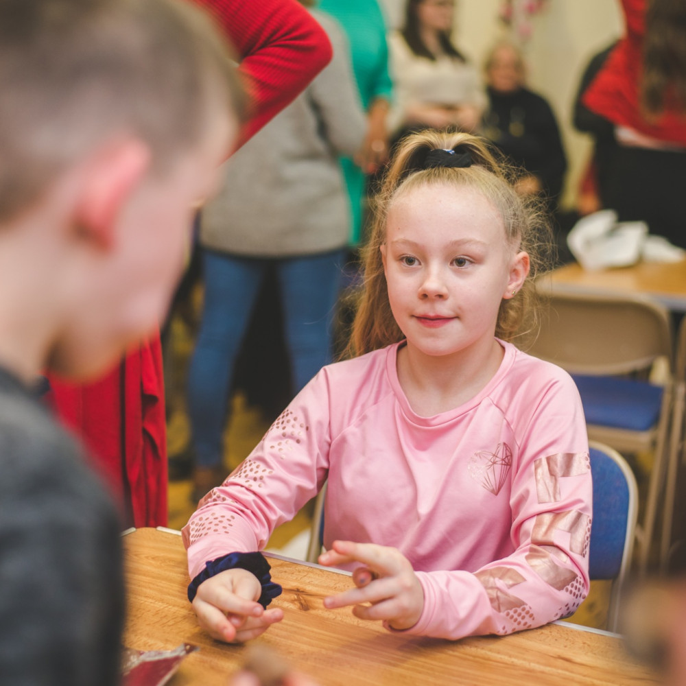 Young girl talking to another child