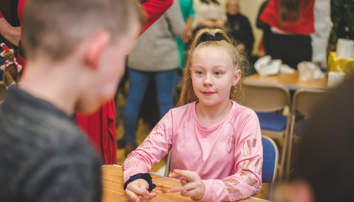 Young girl talking to another child